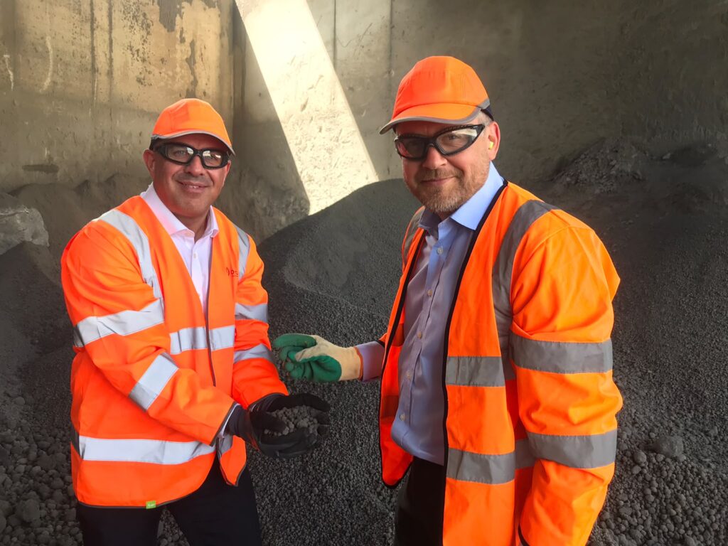 Barry Mellor holds our sustainable aggregate at O.C.O's manufacturing plant in Leeds. Also pictured is Philip Atkinson, MD of O.C.O Technology.